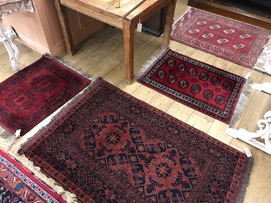 Three Bokhara rugs and a Belouch rug 120 x 92cm, 94 x 69cm, 159 x 101cm and 88 x 70cm